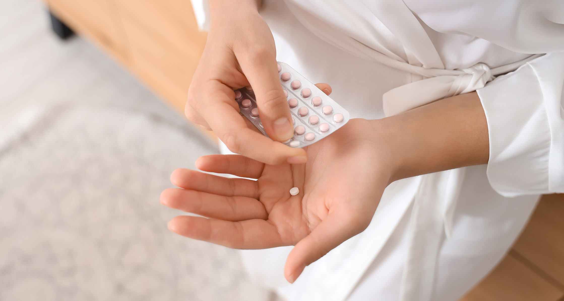 Person holding daily birth control pill.
