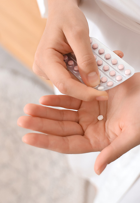 Person holding daily birth control pill.