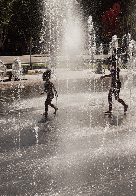 Children playing on neighborhood splash pad.
