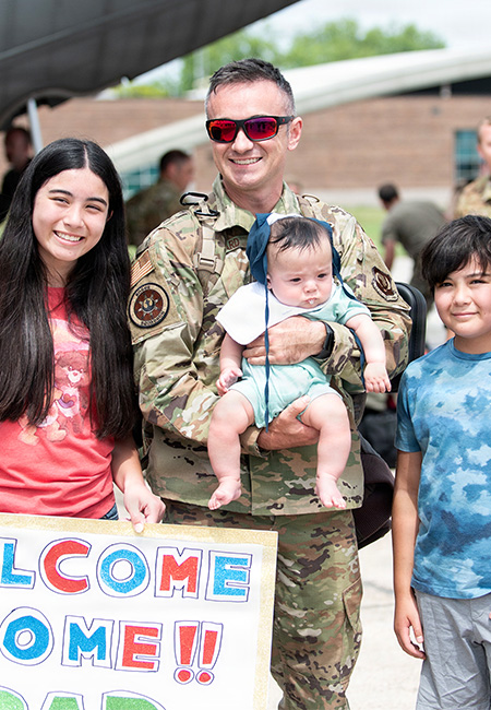 Service member is welcomed home by family.