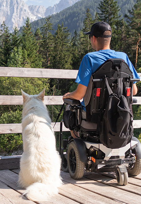 Disabled Veteran spending time outdoors with his dog.