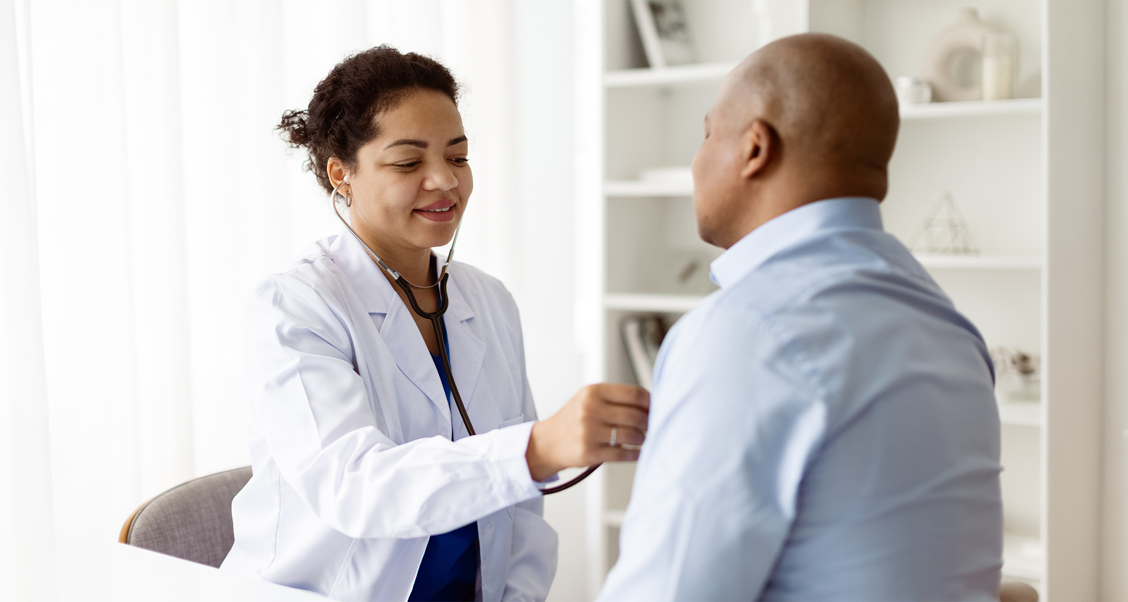 Physician checking patient’s lung health during medical checkup.