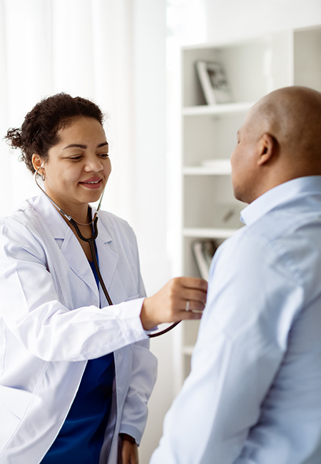 Physician checking patient’s lung health during medical checkup.